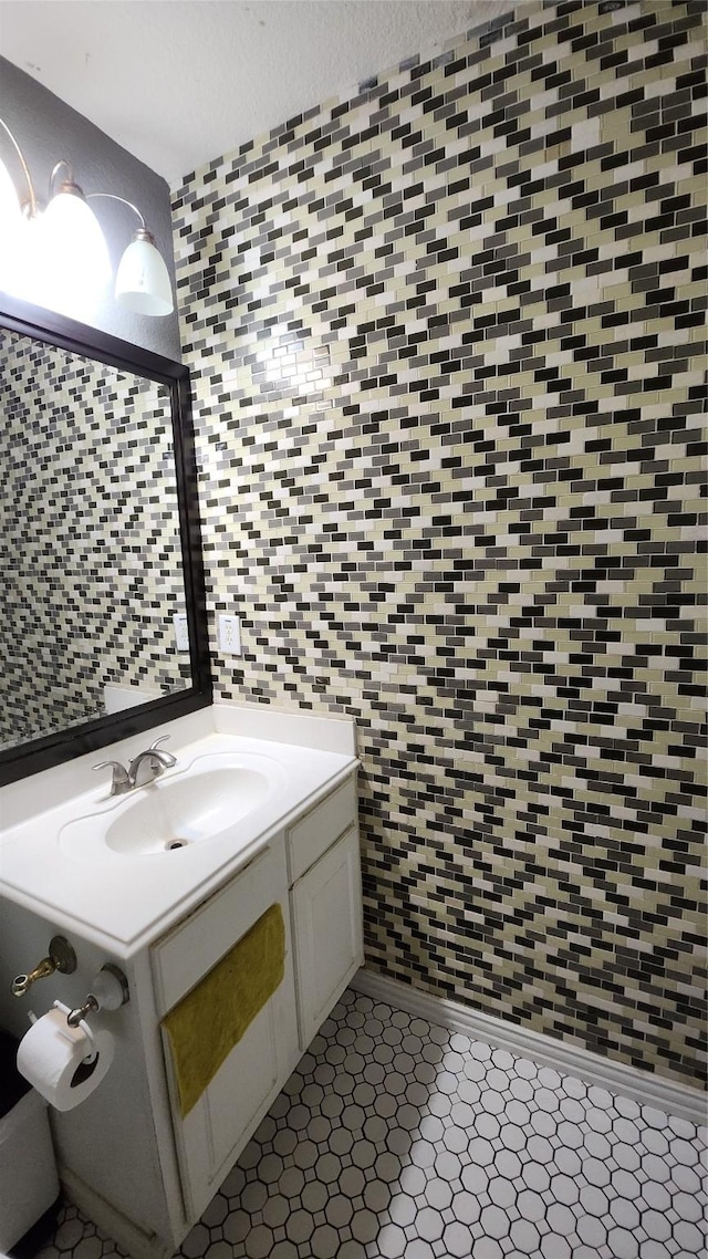 bathroom featuring tile walls and vanity