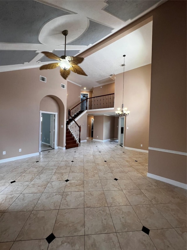 unfurnished living room with stairway, high vaulted ceiling, visible vents, arched walkways, and ceiling fan with notable chandelier