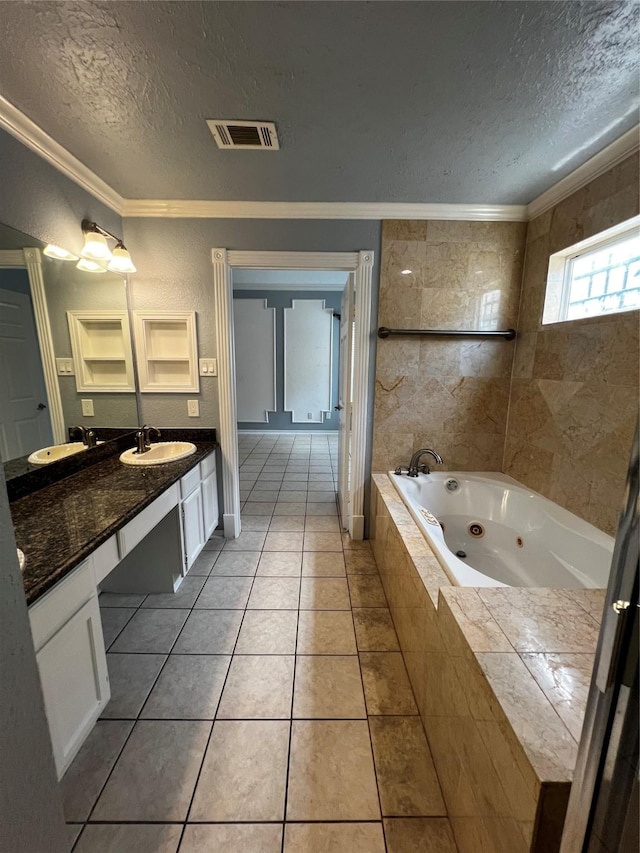 full bath featuring a textured ceiling, visible vents, crown molding, and a sink