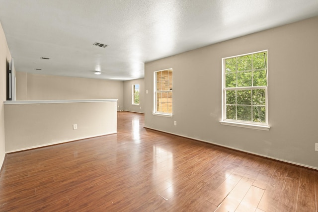 7931 Raven Creek Ln, Cypress, TX 77433 - spare room featuring visible vents, wood finished floors, and baseboards