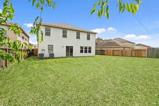 7931 Raven Creek Ln, Cypress, TX 77433 - rear view of house featuring a lawn, a fenced backyard, and central AC unit