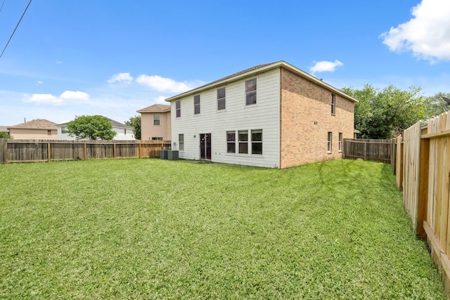 7931 Raven Creek Ln, Cypress, TX 77433 - back of house with a fenced backyard, a yard, and central air condition unit