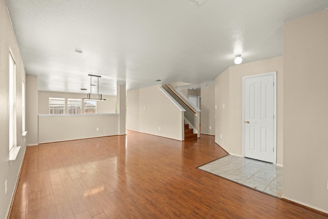 7931 Raven Creek Ln, Cypress, TX 77433 - unfurnished living room featuring wood finished floors, baseboards, and stairs