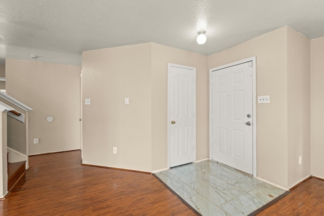 7931 Raven Creek Ln, Cypress, TX 77433 - entryway featuring stairs, wood finished floors, and baseboards