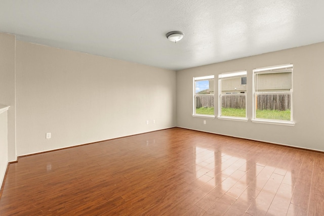 7931 Raven Creek Ln, Cypress, TX 77433 - unfurnished room featuring baseboards and wood finished floors