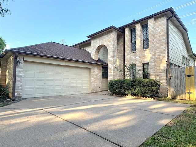 view of front of home featuring stone siding, concrete driveway, a shingled roof, and a garage