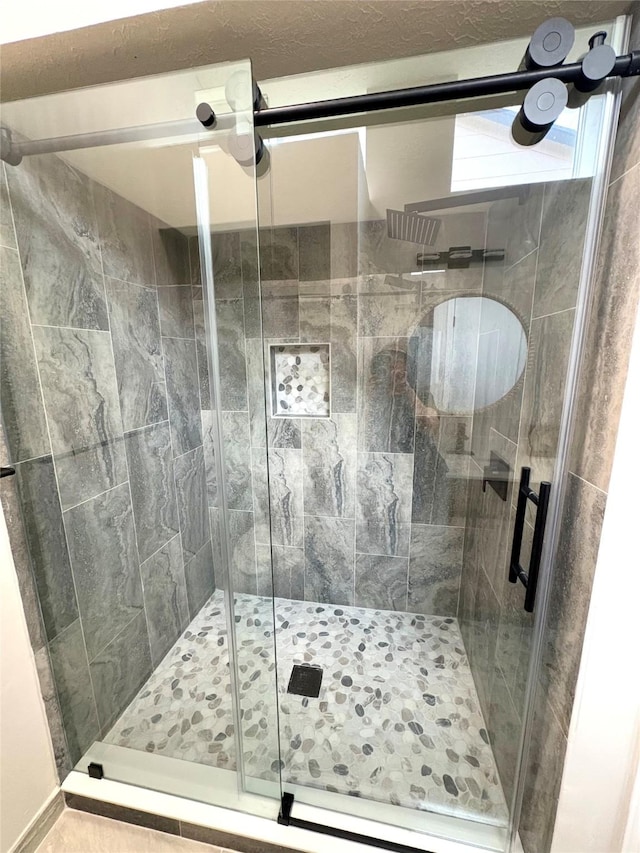 full bath with a shower stall