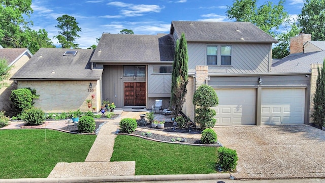 traditional-style house featuring concrete driveway, a front yard, a shingled roof, and brick siding