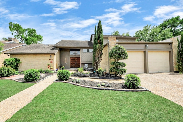 view of front of house featuring a front yard, gravel driveway, a garage, and brick siding