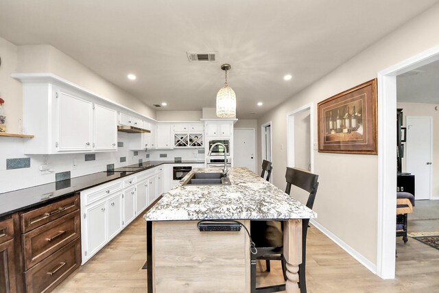 200 Old Bridge Lk, Houston, TX 77069 - kitchen featuring white cabinets, visible vents, a sink, and light wood-type flooring