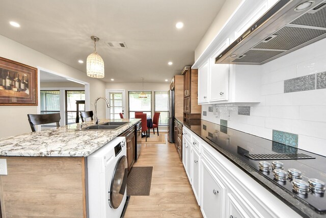 200 Old Bridge Lk, Houston, TX 77069 - kitchen featuring a sink, premium range hood, washer / clothes dryer, recessed lighting, and visible vents