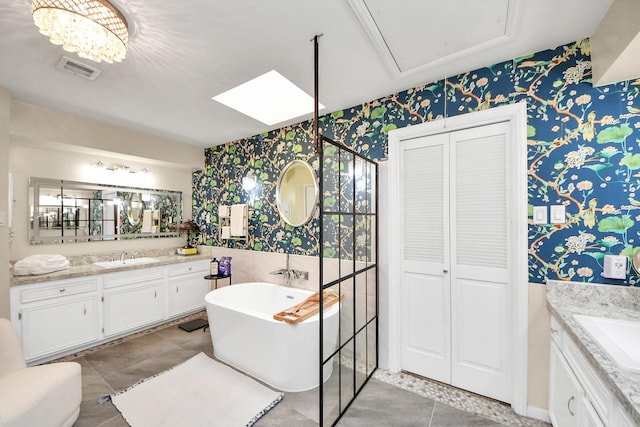 full bath with visible vents, wallpapered walls, and vanity