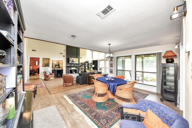 200 Old Bridge Lk, Houston, TX 77069 - playroom featuring a brick fireplace, visible vents, and wood finished floors