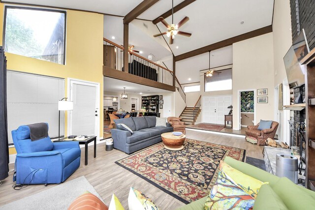 200 Old Bridge Lk, Houston, TX 77069 - living room featuring wood finished floors, beamed ceiling, stairway, high vaulted ceiling, and a ceiling fan