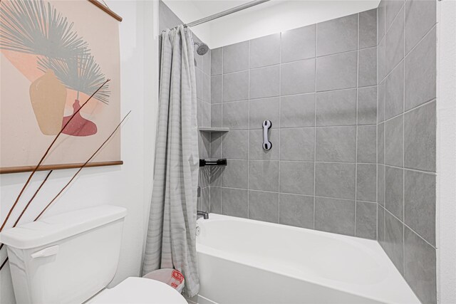 full bath featuring toilet and shower / bath combination with curtain