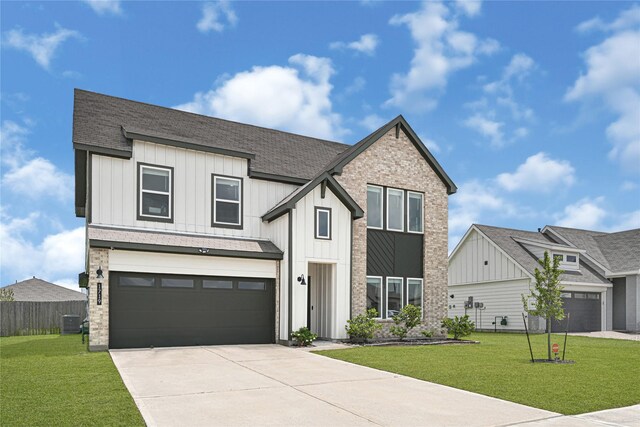 modern farmhouse style home featuring a shingled roof, board and batten siding, driveway, and a front yard