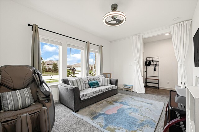 carpeted living area featuring baseboards
