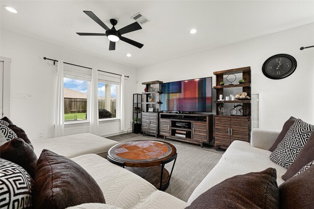 living area featuring light wood-type flooring, a ceiling fan, visible vents, and recessed lighting