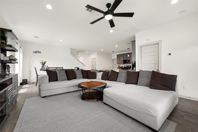 living room featuring recessed lighting, ceiling fan, visible vents, and wood finished floors