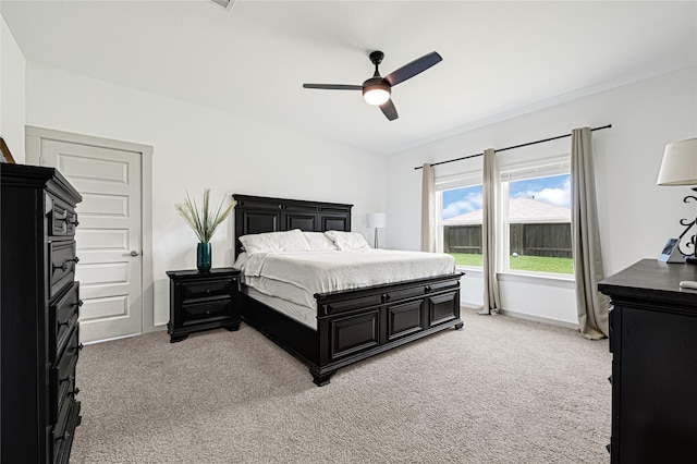 bedroom featuring baseboards, ceiling fan, and light carpet