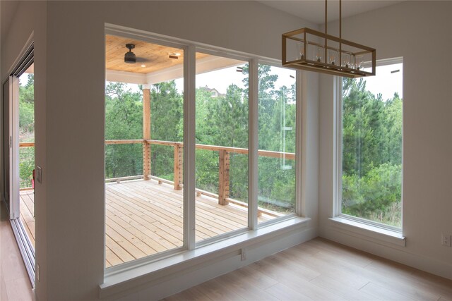 100 Mahalo Ct, Bastrop, TX 78602 - doorway to outside featuring wood finished floors and a chandelier