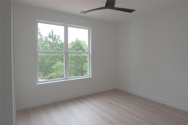 100 Mahalo Ct, Bastrop, TX 78602 - empty room with light wood-style floors, a ceiling fan, and baseboards