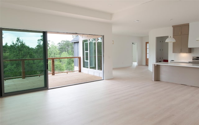100 Mahalo Ct, Bastrop, TX 78602 - unfurnished living room featuring light wood-style floors and baseboards