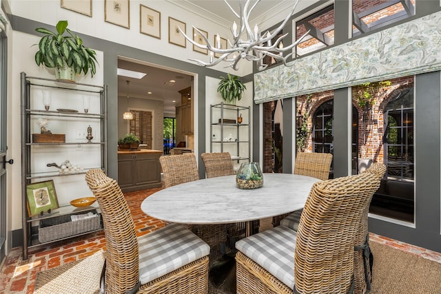 11519 Shadow Way St, Houston, TX 77024 - dining space with crown molding, recessed lighting, a chandelier, and brick floor