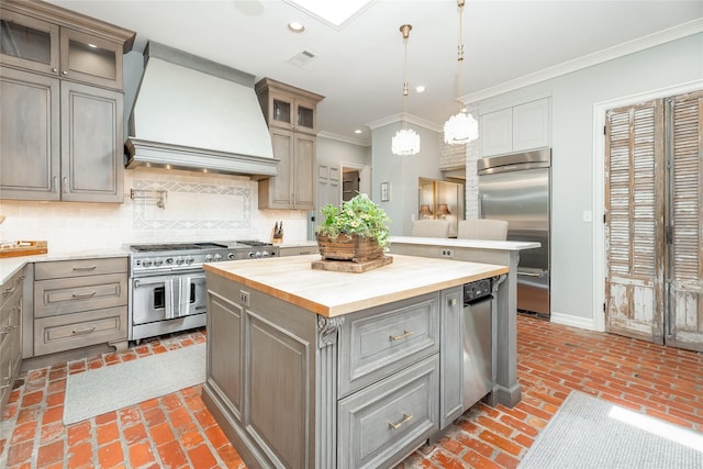 11519 Shadow Way St, Houston, TX 77024 - kitchen with crown molding, wooden counters, premium range hood, high quality appliances, and gray cabinetry