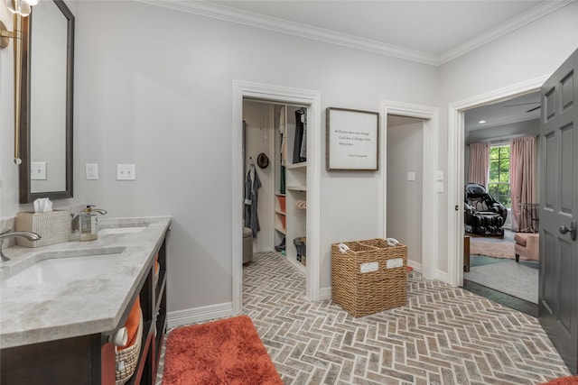 11519 Shadow Way St, Houston, TX 77024 - bathroom with baseboards, brick patterned floor, ornamental molding, and a sink