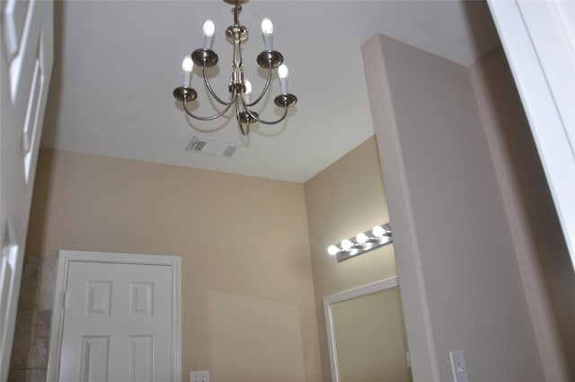 interior details with an inviting chandelier and visible vents