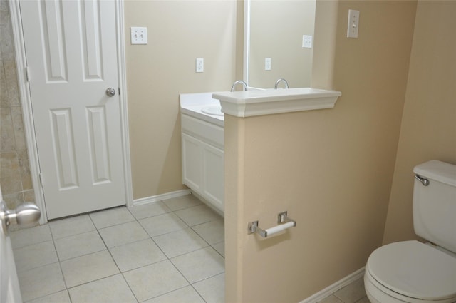bathroom featuring vanity, toilet, tile patterned flooring, and baseboards