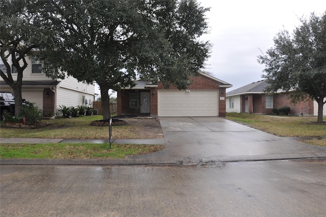 view of front of property with a garage, brick siding, a front yard, and concrete driveway