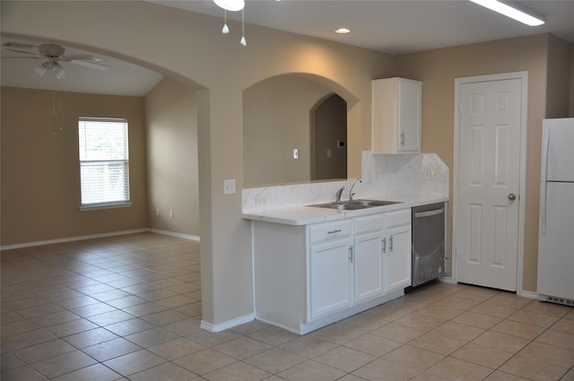 kitchen featuring light tile patterned floors, a sink, freestanding refrigerator, dishwasher, and a ceiling fan