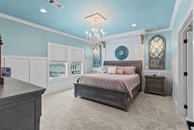carpeted bedroom with a chandelier, visible vents, ornamental molding, and a decorative wall