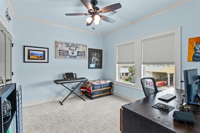 home office featuring carpet, baseboards, visible vents, a ceiling fan, and crown molding