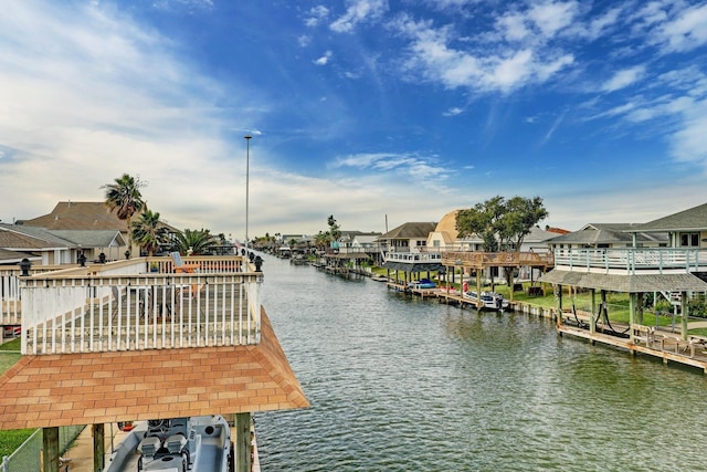 view of dock featuring a residential view and a water view