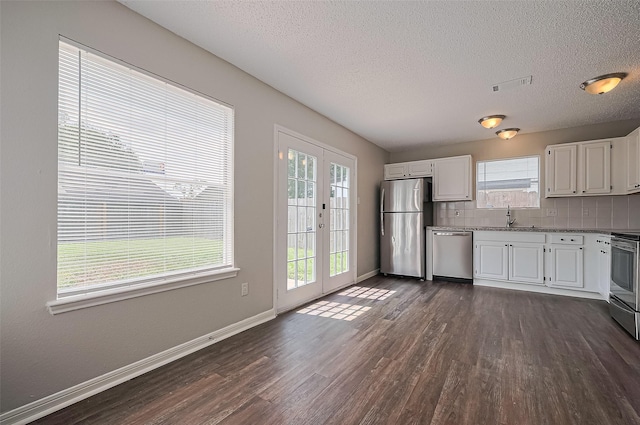 23931 Griffin House Ln, Katy, TX 77493 - kitchen with a healthy amount of sunlight, appliances with stainless steel finishes, dark wood-type flooring, and a sink