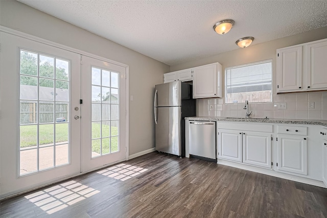 23931 Griffin House Ln, Katy, TX 77493 - kitchen featuring a sink, dark wood-style flooring, stainless steel appliances, a textured ceiling, and french doors