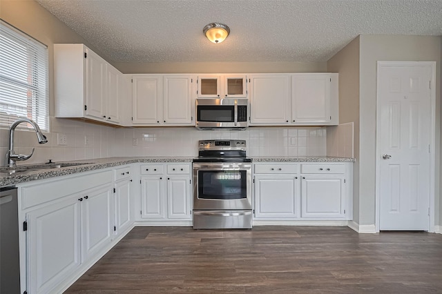 23931 Griffin House Ln, Katy, TX 77493 - kitchen featuring a sink, appliances with stainless steel finishes, and white cabinetry