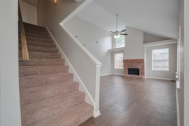 23931 Griffin House Ln, Katy, TX 77493 - stairs featuring ceiling fan, visible vents, baseboards, a fireplace, and wood finished floors