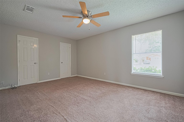 23931 Griffin House Ln, Katy, TX 77493 - empty room featuring visible vents, a ceiling fan, a textured ceiling, and carpet flooring