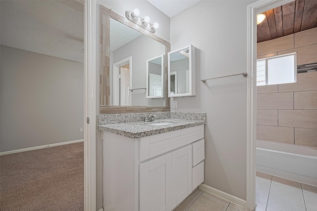 23931 Griffin House Ln, Katy, TX 77493 - full bathroom with tile patterned floors, shower / tub combination, vanity, baseboards, and a textured ceiling