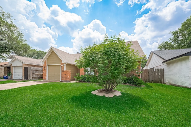 23931 Griffin House Ln, Katy, TX 77493 - view of front of house with brick siding, a front lawn, concrete driveway, and fence