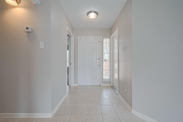 23931 Griffin House Ln, Katy, TX 77493 - entrance foyer with baseboards, light tile patterned floors, and a textured ceiling