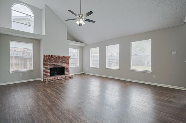 23931 Griffin House Ln, Katy, TX 77493 - unfurnished living room with dark wood-type flooring, baseboards, ceiling fan, and a brick fireplace