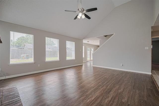 23931 Griffin House Ln, Katy, TX 77493 - unfurnished living room with dark wood-type flooring, a ceiling fan, high vaulted ceiling, and baseboards
