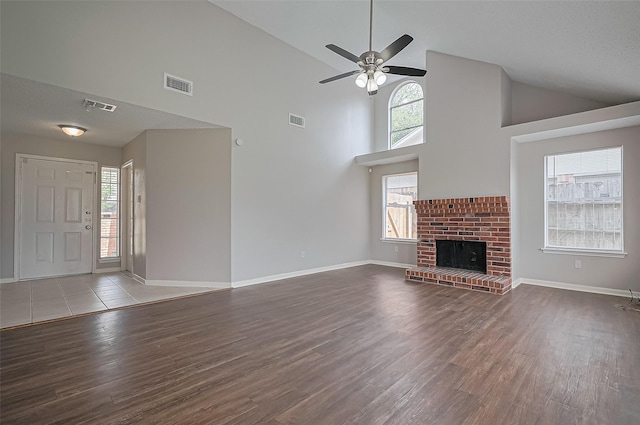 23931 Griffin House Ln, Katy, TX 77493 - unfurnished living room featuring visible vents, wood finished floors, and high vaulted ceiling