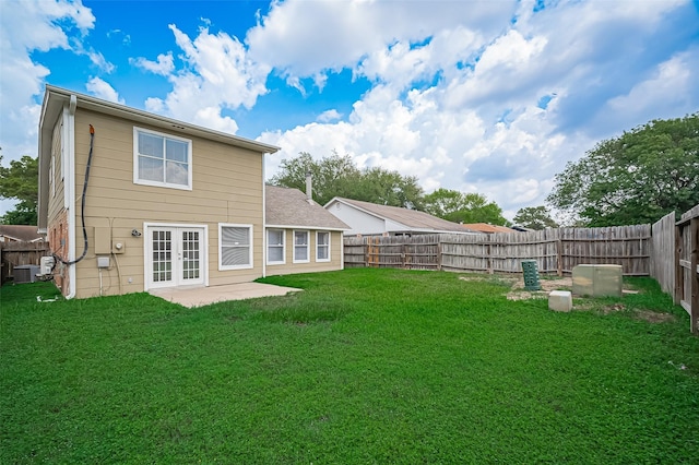 23931 Griffin House Ln, Katy, TX 77493 - back of house with a fenced backyard, a yard, central air condition unit, a patio area, and french doors