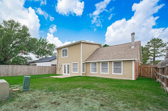 23931 Griffin House Ln, Katy, TX 77493 - rear view of property with a chimney, french doors, a fenced backyard, and a yard